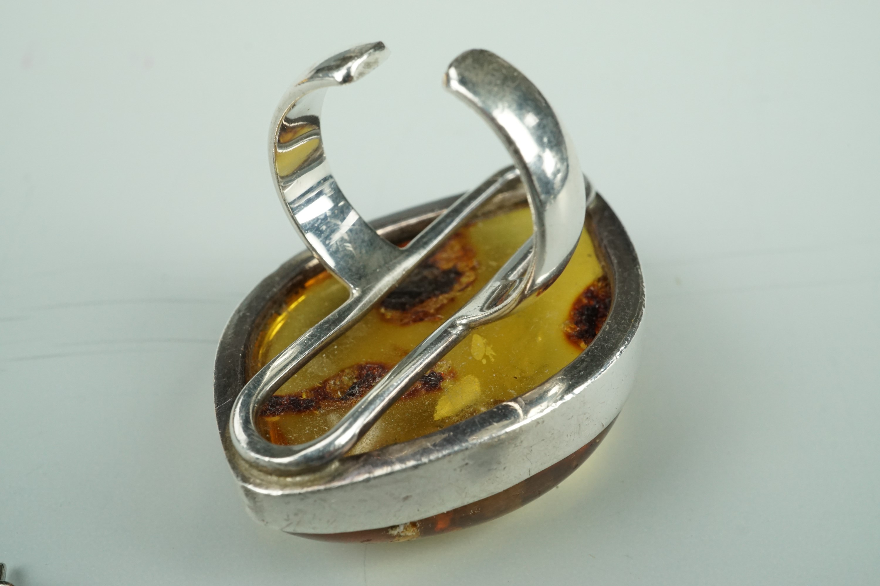A large asymmetric amber cabochon ring, bezel-set in white metal, stamped 925 and tested as - Image 2 of 7