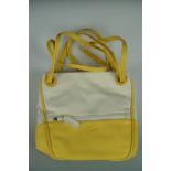 A vintage "as new" unused Lacoste shoulder bag, in lemon yellow PVC and cream canvas, lined with