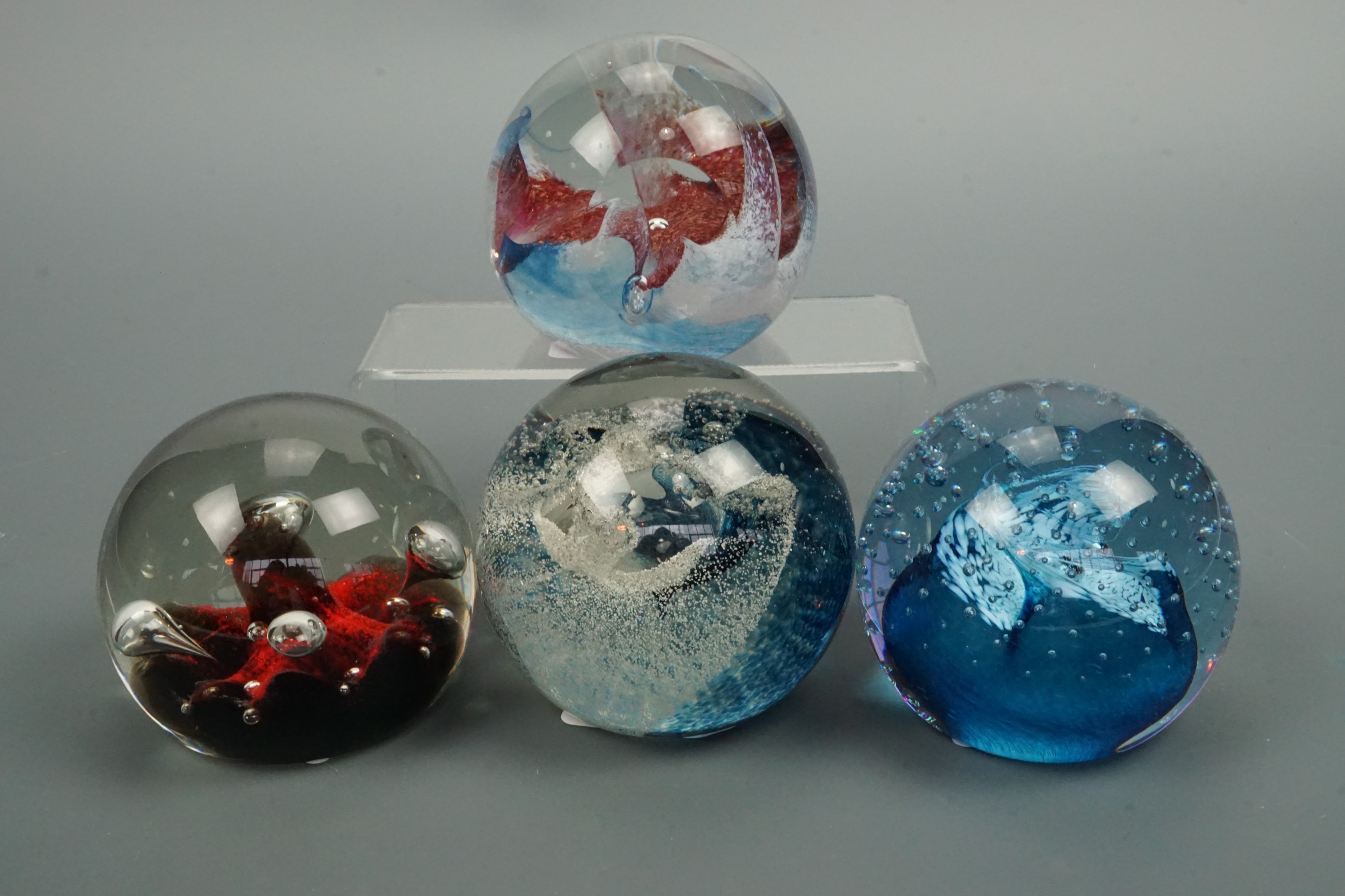 Four Caithness paperweights including Moonflower and Splash Down