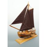 A small wooden model sailing boat, 33 cm long