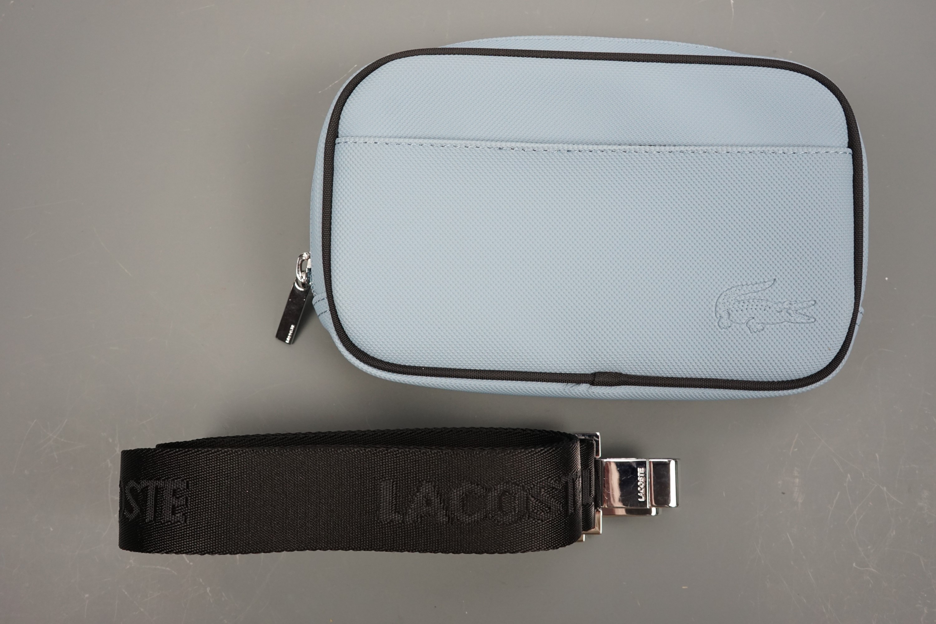 An "as new" unused Lacoste Classic II convertible clutch / hip / bum / waist / shoulder bag in