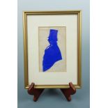 A cut paper silhouette of a gentleman wearing a mid Victorian top hat, framed and mounted under