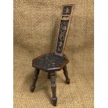 A carved oak spinning stool