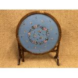 A 1930s oak folding screen / table with circular tapestry top, 60 cm