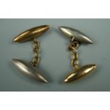 A pair of early 20th Century silver and yellow metal torpedo cufflinks