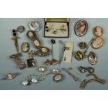 A quantity of vintage costume jewellery including cameos, a faux pearl cloak clasp, foliate white