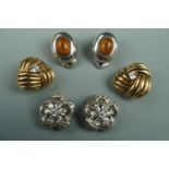 Three pairs of vintage white-metal statement ear clips, one pair modelled as flower heads,