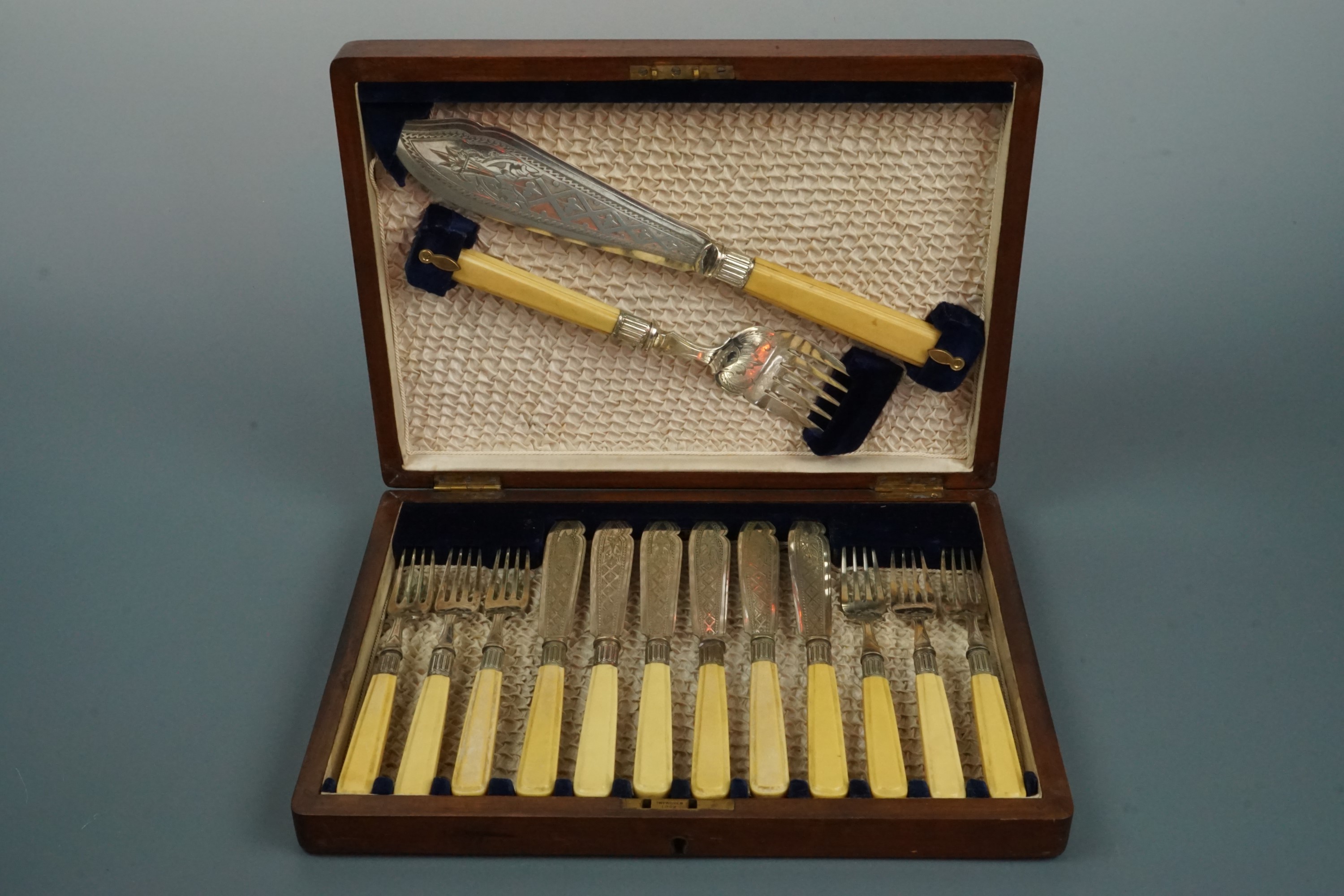 A cased set of fish servers and fish eaters
