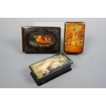 Three Soviet / Russian lacquered boxes, painted in depiction of a fairy tale troika, a cathedral and