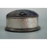 An Edwardian Arts and Crafts influenced silver mounted ring box / hat pin cushion, William Comyns,
