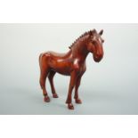 A Chinese carved wooden horse, having inset glass eyes, 14 cm