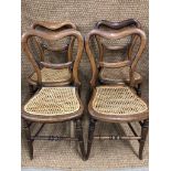 A set of four Victorian cane-seated balloon-back bedroom chairs