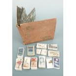 A cigarette card album and loose cigarette cards