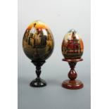 Two 1990s Russian lacquer eggs depicting the Kremlin and St Basil's Cathedral, Moscow, signed and