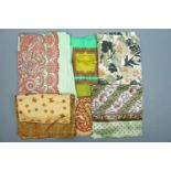 A collection of vintage scarves, including one novelty comparing old and new systems of