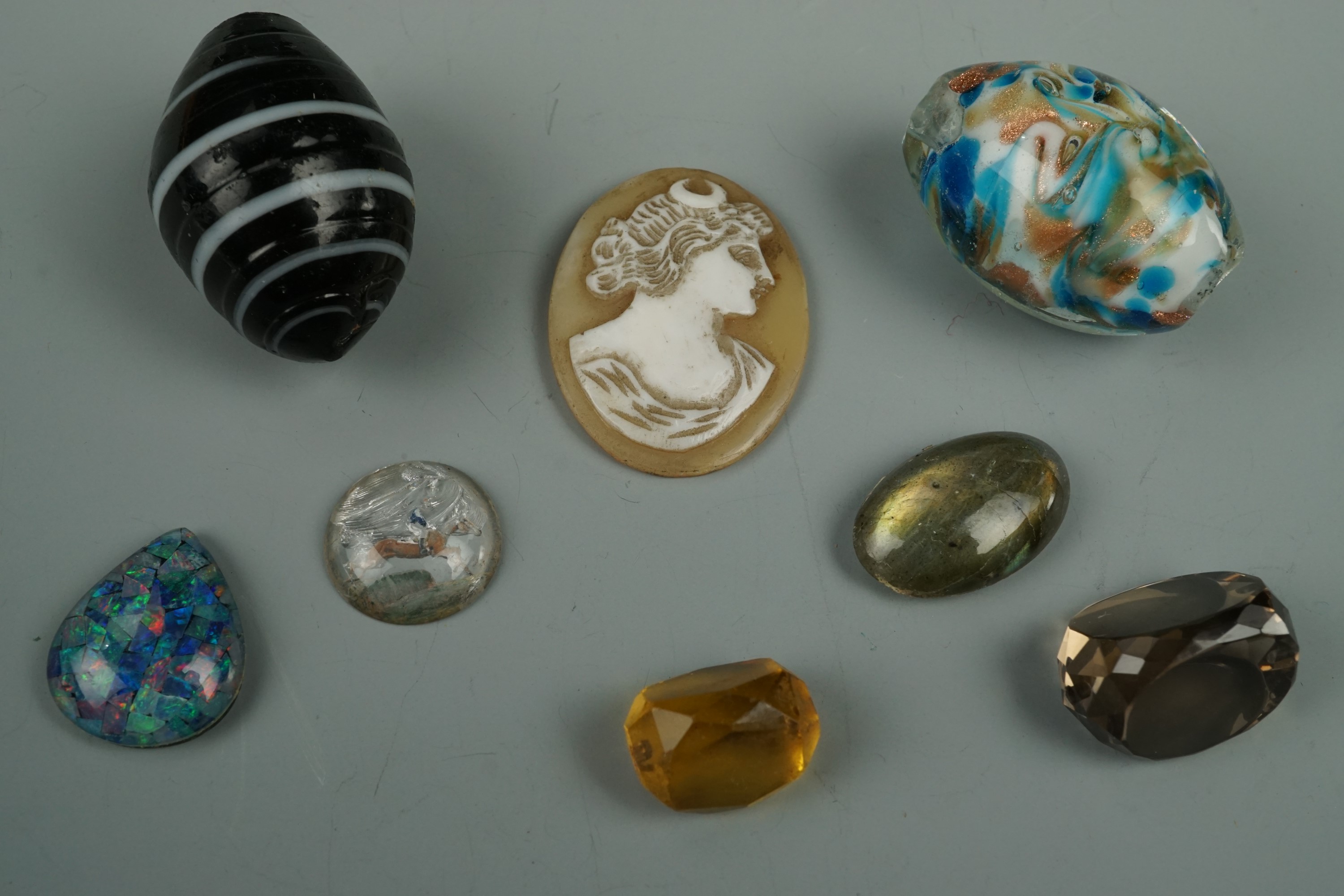 A small group of un-mounted semi-precious gems etc including a 19th Century Essex crystal reverse