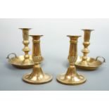 A pair of chamber sticks, 19 cm high, together with a pair of brass candlesticks