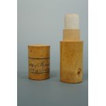 A treen cylindrical container labelled "Copy of Freedom, City of London", containing a parchment