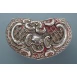 An Edwardian silver pill or snuff box, kidney-shaped, its lid decorated in a Rococo scroll and