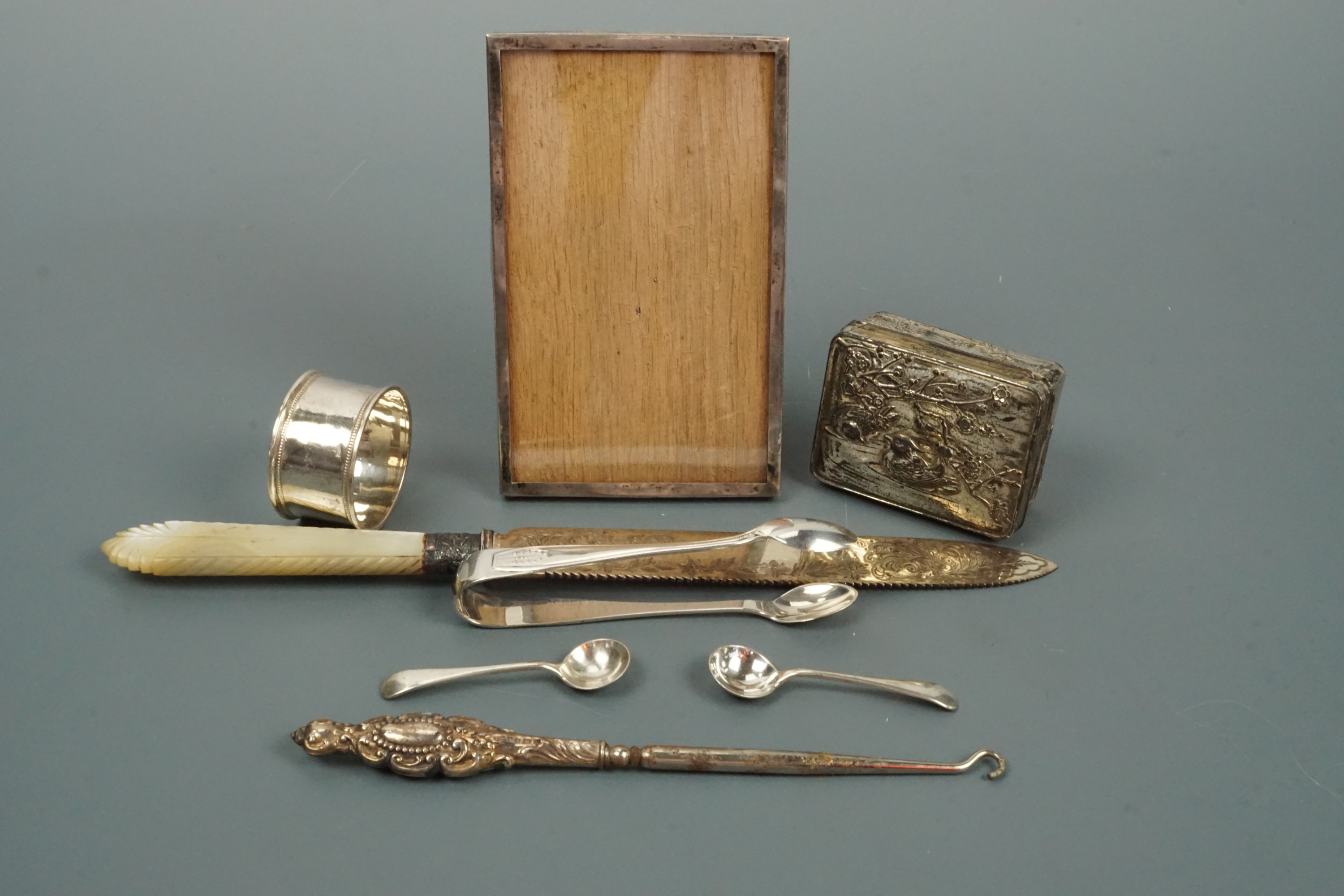 A Silver napkin ring, sugar tongs and salt spoons together with a silver collared bread knife,