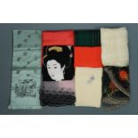 A collection of vintage silk and other scarves, including one depicting a Geisha