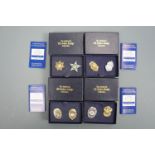 Four cased pairs of miniature replica US police badges