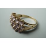 A contemporary Rose de France amethyst dress ring, having three rows of sixteen claw set