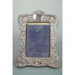 An Edwardian Art Nouveau silver-faced photograph frame, 21 cm high