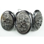 A Victorian faux-jet bracelet of graded oval convex plaques each decorated in relief depiction of