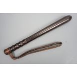 A British military police truncheon, in turned ebony or a similar hardwood with leather wrist strap,