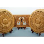 Two French Guyanan Arawak carved wooden circular plaques, 42 cm diameter, together with one other