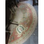 Circular Indian woollen carpet of floral design on ivory ground