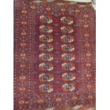 Small Turkoman rug with two rows of gols on a red ground with borders, together with a similar