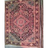 Small modern Tabriz mat with a medallion and all-over floral design on a midnight blue ground with