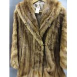 Ladies mid tan three quarter length fur coat, together with two fur stoles and three fur hats