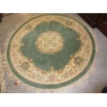 Chinese circular woollen rug of floral design on sage green ground, together with a similar