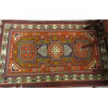 Small Turkish rug with a triple hooked medallion Caucasian design on a rust ground, 5ft x 3ft 2ins