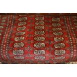 Pakistan rug of Turkoman design with three rows of gols on a wine ground