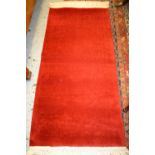 Three various small Chinese red ground rugs