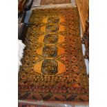 Afghan gold ground rug with five gols, 6ft 6ins x 3ft 6ins approximately together with a Pakistan