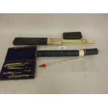 Cased slide rule, cased thermometer and a leather cased part drawing instrument set