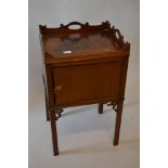 George III mahogany bedside cabinet with a galleried top above a single panelled door raised on