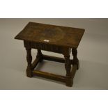 Good quality reproduction carved oak joint stool with a plank top above carved frieze on bulbous and