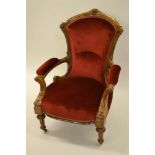 Victorian walnut open armchair with upholstered back, seat and arms, raised on turned fluted