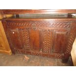 Antique oak coffer adapted for use as a cupboard, the moulded top above a carved frieze, two doors