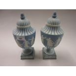 Pair of Wedgwood pale blue Jasperware baluster form pedestal vases with covers decorated with