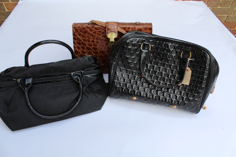 Two Jaeger ladies black patent leather handbags, together with a leather simulated crocodile handbag