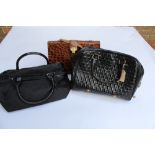 Two Jaeger ladies black patent leather handbags, together with a leather simulated crocodile handbag