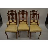 Edwardian walnut drawing room suite comprising: chaise longue, pair of wing armchairs and a set of