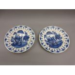 Pair of circular Delft pottery blue and white fruit and floral decorated plates (one hairline